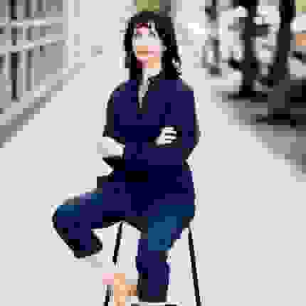 Anita Zeppetelli sitting on a stool