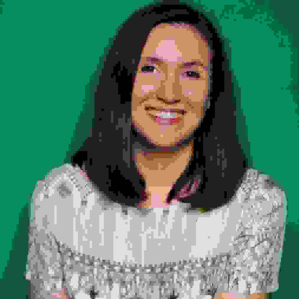 Portrait of Christina Roussos against a green background