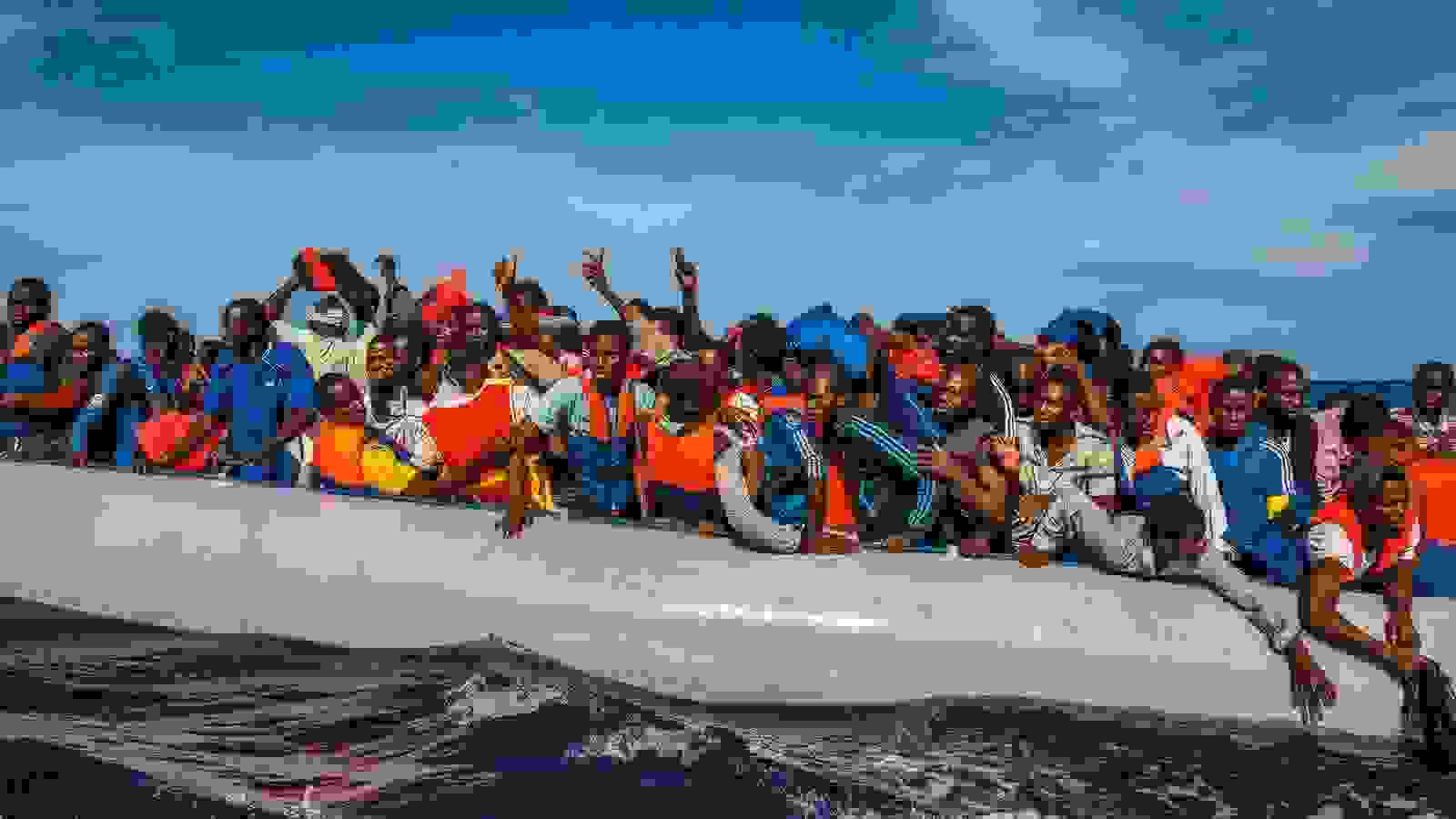 One hundred and nine African refugees from Gambia, Mali, Senegal, Ivory Coast, Guinea, and Nigeria are rescued by the Italian navy from a rubber boat in the sea between Italy and Libya, October 2014. 