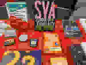 A red table with 5-6 SVA informational pamphlets and booklets on display.