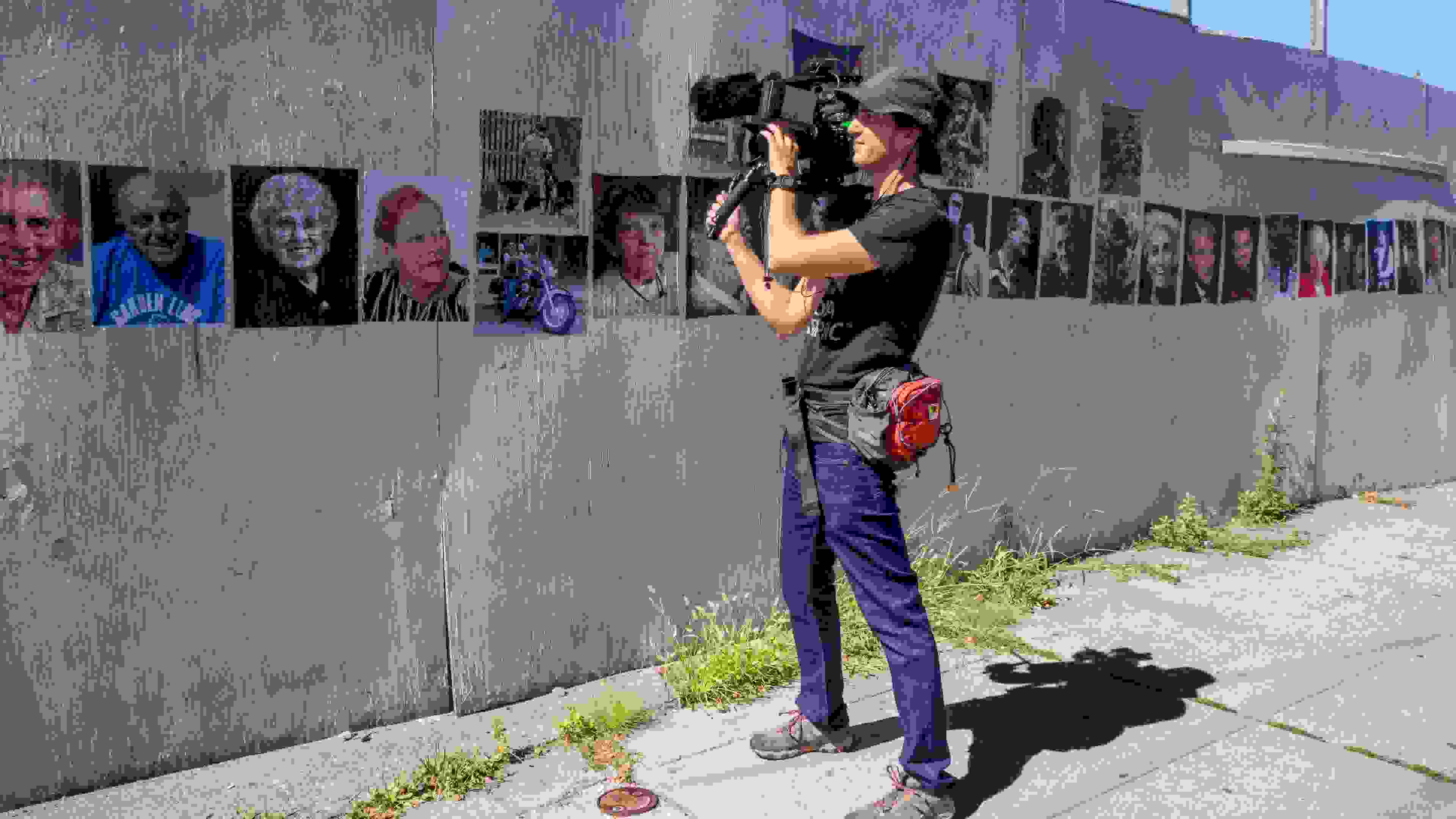 MFA SocDoc student holding a camera on the street.